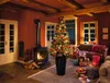 A cozy living room decorated for Christmas, featuring a fireplace, a Christmas tree, and a sofa. Produktbild-Vorschau