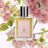 A bottle of Acca Kappa Giardino segreto Eau de Parfum is displayed in front of a backdrop of blooming pink cherry blossoms. Podgląd zdjęcia produktu