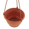 A close-up view of a brown hanging planter pot with three strings attached for hanging. Produktbild-Vorschau