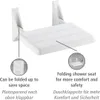 A white folding shower seat mounted on a wall, with inset images and text highlighting its features. Produktbild-Vorschau