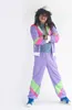 A man in a retro tracksuit stands with his arms crossed against a white background. Produktbild-Vorschau