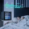 A mini refrigerator is shown next to a person sleeping in bed, with a graphic overlay illustrating noise levels. Produktbild-Vorschau