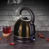 A black electric kettle is shown steaming next to a glass of tea on a countertop. Náhled obrázku produktu