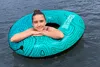 A young person is floating in the water on a tube. Anteprima dell’immagine prodotto