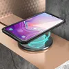 A smartphone in a black case is placed on a wireless charger, which is emitting blue light. Voir les images du produit
