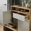A shoe cabinet with an open door, revealing shoes inside, and a drawer partially open. Náhľad obrázku produktu