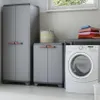 A laundry room scene with storage cabinets and a washing machine. Voir les images du produit