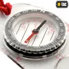 A close-up of a compass with a red string attached. Produktbild-Vorschau