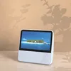 A white portable DVD player is shown on a light-colored surface, with shadows of leaves cast on a light brown wall in the background. Náhľad obrázku produktu