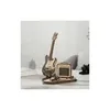 A wooden model of an electric guitar and amplifier on a stand, displayed on a table. Voir les images du produit