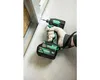 A person wearing a glove is using a HiKOKI cordless impact driver to screw into a metal stud. Voir les images du produit
