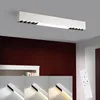 A modern white rectangular LED ceiling light fixture is shown mounted on a ceiling above a dark red wall. Below the main fixture, three smaller images show the light fixture at different color temperatures and intensities. A white remote control is also vi Anteprima dell’immagine prodotto