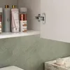 Close-up view of a bathroom cabinet interior with various cosmetic products on a shelf and a cabinet hinge visible. Produktbild-Vorschau