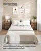 A bedroom scene with a bed, nightstands, and wall art. Produktbild-Vorschau