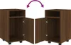 Two identical brown wooden cabinets with open doors, shown side-by-side with a curved arrow above indicating movement or comparison. Náhľad obrázku produktu