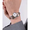 A woman's wrist wearing a silver watch and bracelet. Produktbild-Vorschau