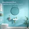 A small bathroom with a toilet, sink, mirror, and plant. Anteprima dell’immagine prodotto