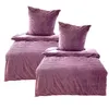 Two sets of purple bedding with pillows are arranged on a white background. Produktbild-Vorschau