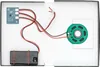 The inside of an open box showing electronic components for a toy or gadget. Produktbild-Vorschau