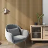 A cozy corner with a grey armchair, a side table, and a wooden slatted wall. Anteprima dell’immagine prodotto