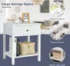 A white nightstand with a drawer and open shelf, styled with decorative items and books. Inset images highlight specific features like the tabletop, drawer, and bottom shelf. Podgląd zdjęcia produktu