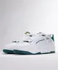 A pair of white Puma sneakers with green accents, displayed on a white surface against a white background. Produktbild-Vorschau