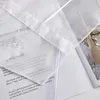 A close-up of a white fabric with text printed on it, possibly a product description or marketing material. Produktbild-Vorschau