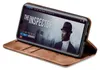 A smartphone in a brown flip case is displayed at an angle, showing the phone screen with a movie playing. Produktbild-Vorschau