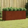 A rectangular planter filled with green plants sits on a grassy lawn in front of a wooden fence. Voir les images du produit