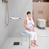 A pregnant woman sits on a shower stool in a modern bathroom, holding a water bottle. Náhľad obrázku produktu