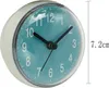 A close-up, angled view of a small, round clock with a blue face and white numbers. Produktbild-Vorschau