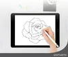 A hand is using a stylus to draw a rose on a tablet, which is placed on a desk with some office supplies. Produktbild-Vorschau