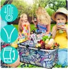 A family enjoying a picnic in a park with a picnic basket filled with food. Náhled obrázku produktu