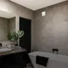 A modern bathroom with a bathtub, sink, and a ventilation fan. Voir les images du produit