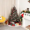 A decorated Christmas tree with presents underneath, next to a fireplace with Christmas decorations. Produktbild-Vorschau