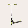 A white and black stunt scooter with green accents is shown against a plain background. Náhled obrázku produktu
