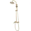 A gold-colored shower set with a rain showerhead and a handheld showerhead, mounted on a white background. Náhľad obrázku produktu