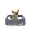 A small dog sits in a dog bed. Náhľad obrázku produktu