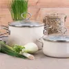 Two cream-colored pots with glass lids are arranged on a counter, with fresh vegetables and a jar of rice in the background. Náhled obrázku produktu