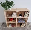 A wooden crate shelf unit with various decorative items and books. Produktbild-Vorschau