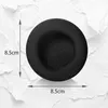 A black headphone earpad is shown against a textured white and gray background. Dimensions are indicated with arrows and text. Náhled obrázku produktu