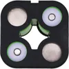 A top-down view of a black battery holder with four circular compartments. Two compartments contain metallic discs, and the other two contain white discs with a metallic center and a green ring around them. Produktbild-Vorschau