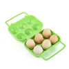 A green plastic egg carton with six eggs inside, shown on a white background. Produktbild-Vorschau