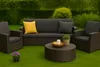 Outdoor furniture set on a lawn with a hedge and bushes in the background. Voir les images du produit