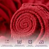 A close-up, rolled-up view of a red fabric, likely a bedsheet, with care instructions and feature icons displayed at the bottom. Produktbild-Vorschau