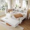 A white daybed with a trundle bed pulled out, set up in a bright room with large windows. Náhled obrázku produktu