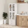 A white kitchen cabinet with glass doors and drawers stands in a room with a plant and a wooden countertop. Voir les images du produit