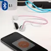 A pair of pink and white bone conduction headphones are placed on a white surface next to a smartphone displaying a connection interface. In the background, there are exercise accessories like a jump rope and weights. Produktbild-Vorschau