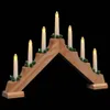 A wooden candle bridge with seven LED lights and green decorative elements, set against a black background. Voir les images du produit