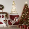 A cozy living room decorated for Christmas, featuring a fireplace, a chair, and a Christmas tree. Podgląd zdjęcia produktu